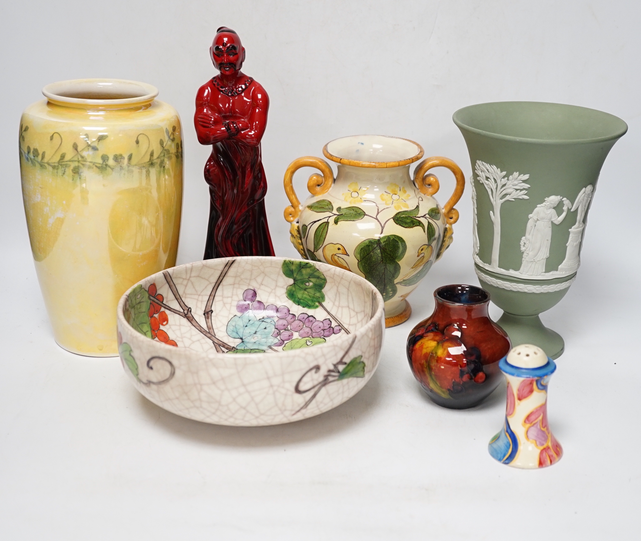 Five ceramic items including a Wedgwood pedestal vase, a Ruskin lustre glaze vase, a Doulton flambé 'The Genie', etc.